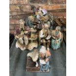 SIX CHALKWARE FIGURINES FEATURING A COUPLE PLAYING CARD GAMES, LADY WITH DONKEY AND CART ETC