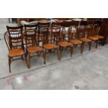 A SET OF EIGHT ELM R.W.F.CO WINDSOR STYLE DINING CHAIRS WITH STICK BACKS AND CRINOLINE BOWS