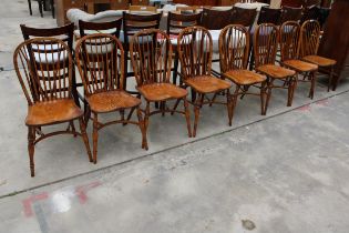 A SET OF EIGHT ELM R.W.F.CO WINDSOR STYLE DINING CHAIRS WITH STICK BACKS AND CRINOLINE BOWS
