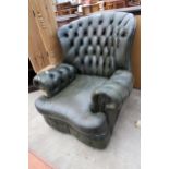 A MODERN GREEN LEATHER BUTTON-BACK WINGED EASY CHAIR