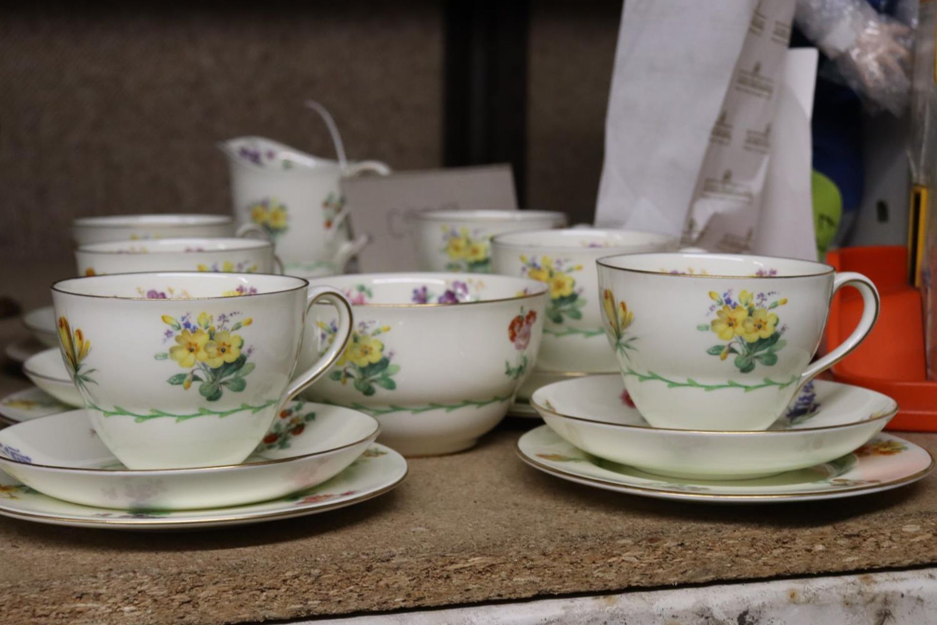 A VINTAGE ROYAL DOULTON TEASET, PALE YELLOW WITH SPRING FLOWERS, TO INCLUDE A CREAM JUG, SUGAR BOWL,