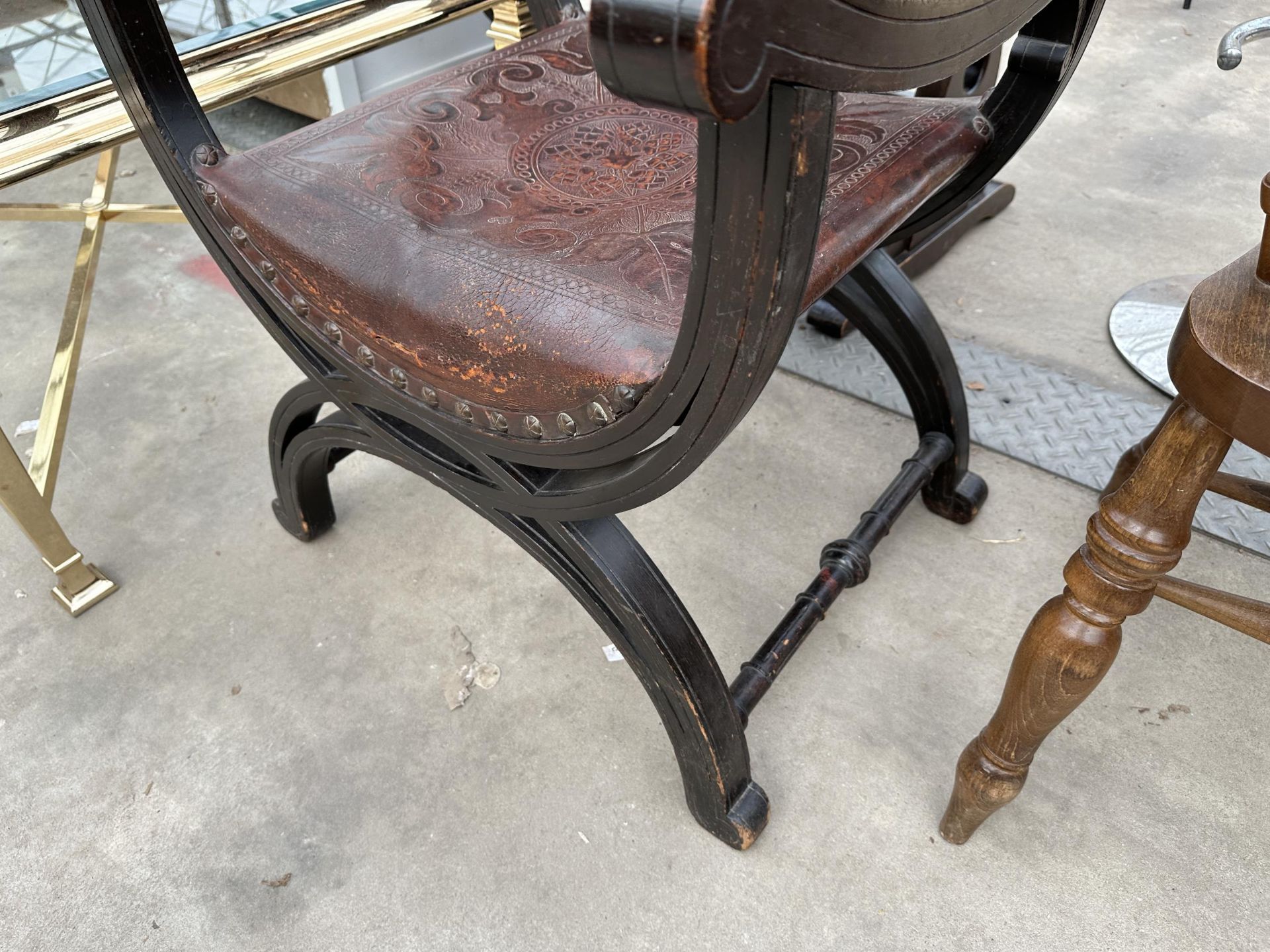 A VICTORIAN CROSS FRAMED ELBOW CHAIR WITH EMBOSSED LEATHER BACK AND SEAT - Image 4 of 4