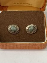 A PAIR OF SILVER CUFFLINKS IN A PRESENTATION BOX