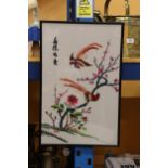 AN ORIENTAL EMBROIDERY ON SILK OF BIRDS IN A CHERRY TREE