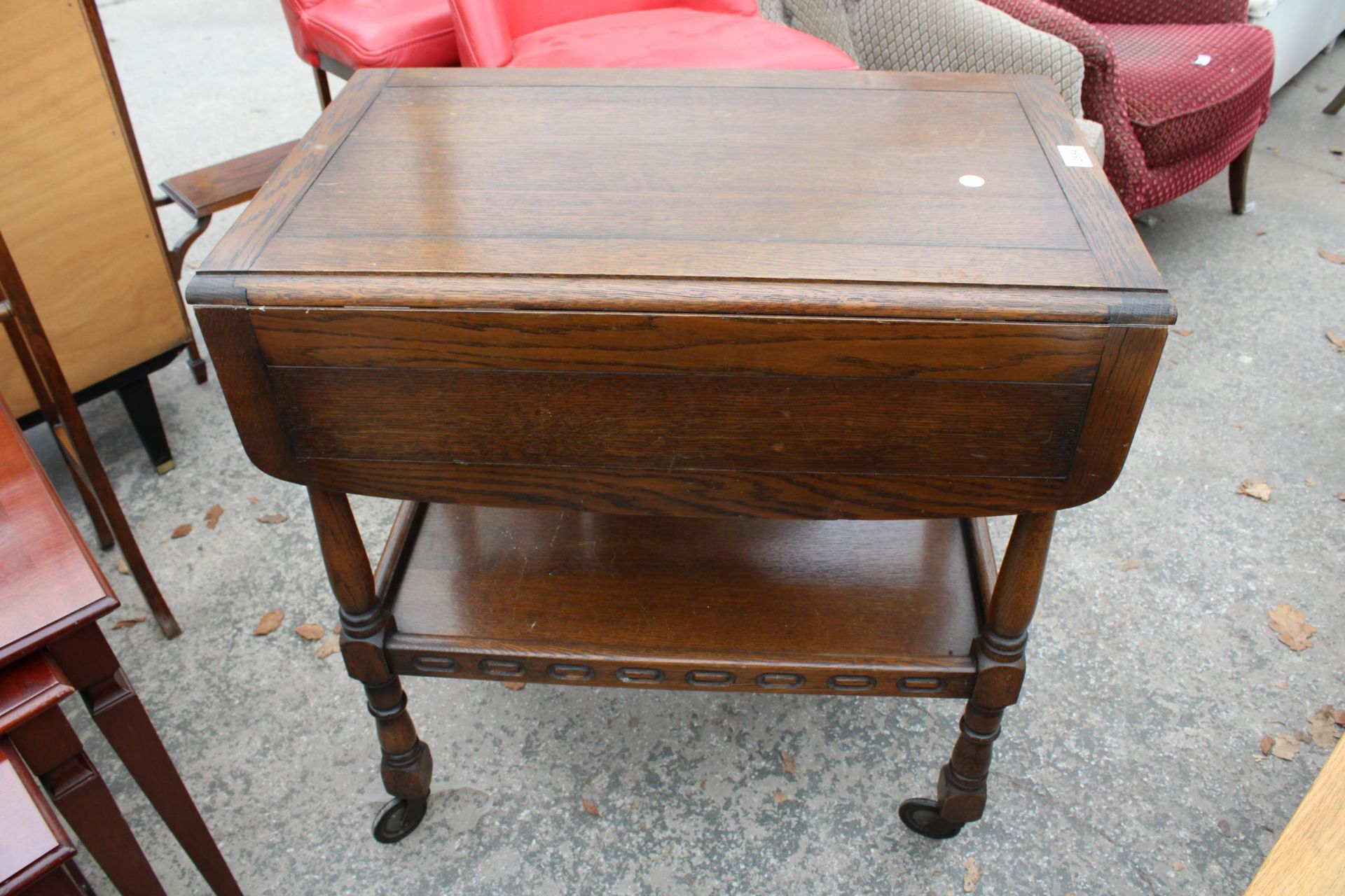 A MID 20TH CENTURY OAK TWO TIER DROP-LEAF TROLLEY