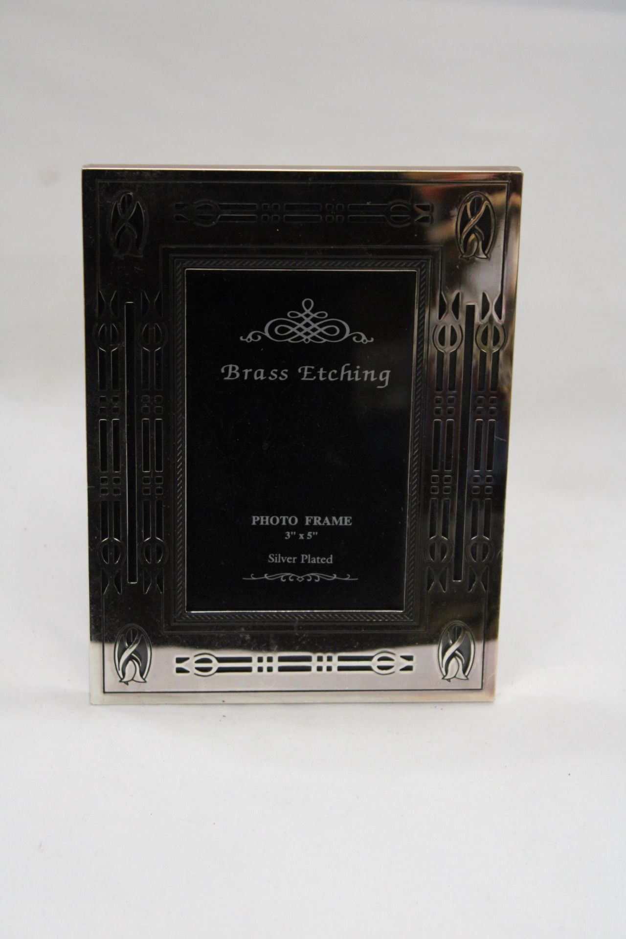 A RENNIE MACINTOSH STYLE SILVER PLATED PHOTO FRAME