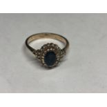 A 9 CARAT GOLD RING WITH TOPAZ SURROUNDED BY DIAMONDS ALSO ON THE SHOULDERS SIZE R/S GROSS WEIGHT