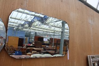 A FRAMELESS WALL MIRROR WITH FLORAL DECORATION, 27" X 16"