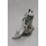 A NAO FIGURINE OF A CLOWN ON A ROCK