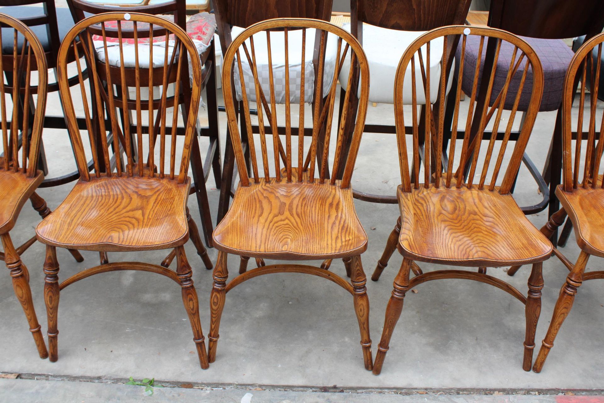 A SET OF EIGHT ELM R.W.F.CO WINDSOR STYLE DINING CHAIRS WITH STICK BACKS AND CRINOLINE BOWS - Image 3 of 9