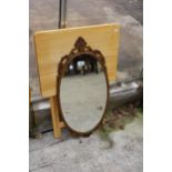 A MODERN OVAL METALWARE FRAMED WALL MIRROR AND FOLDING TABLE