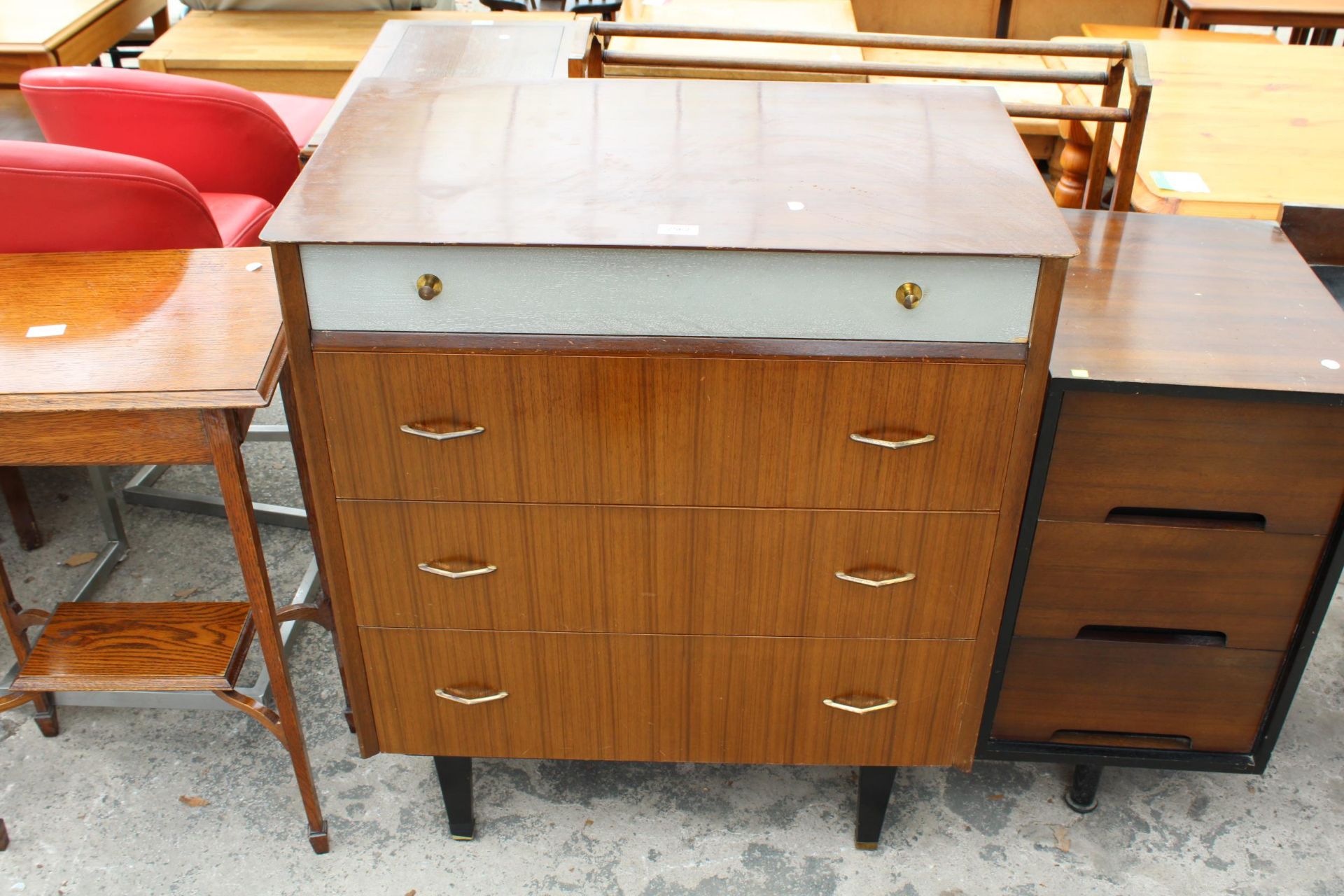 A RETRO TEAK CHEST OF FOUR DRAWERS, THE TOP DRAWER BEING SILVER COLOURED, ALL WITH BRASS HANDLES