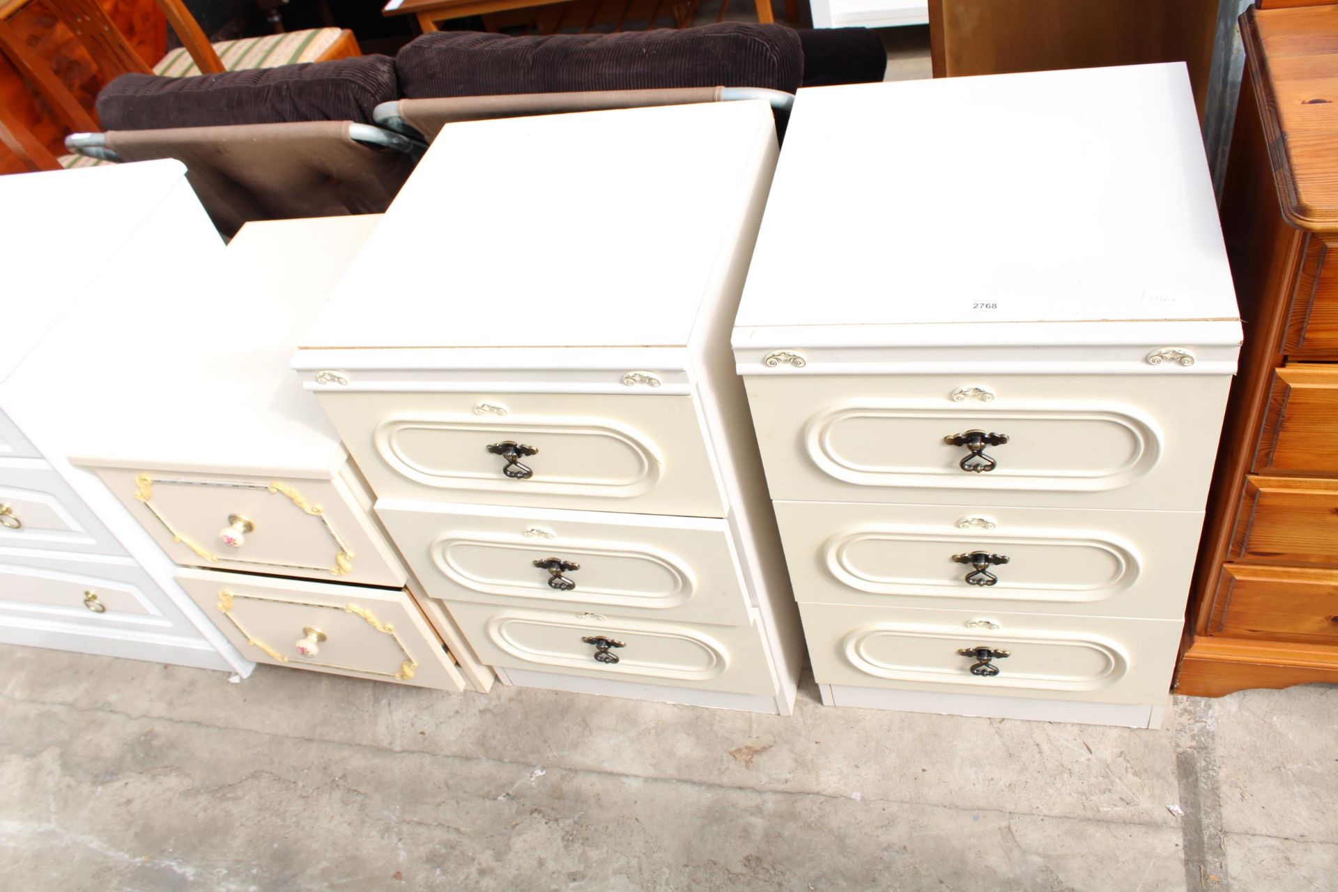 A PAIR OF MODERN CREAM BEDSIDE CHESTS AND ONE OTHER