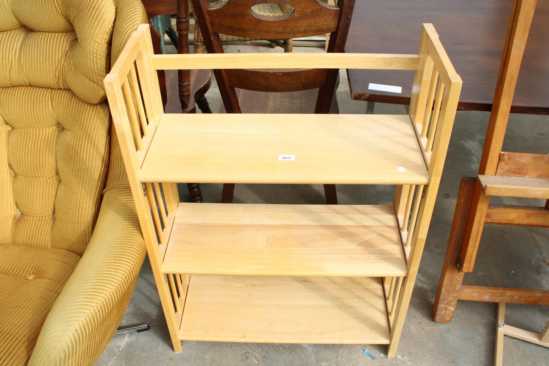 A MODERN HARDWOOD FOLDING THREE TIER OPEN BOOKCASE