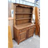 A REPRODUCTION OAK DRESSER WITH LINEN FOLD DOORS AND PLATE RACK, L.MARCUS LTD (LONDON) 48" WIDE