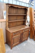 A REPRODUCTION OAK DRESSER WITH LINEN FOLD DOORS AND PLATE RACK, L.MARCUS LTD (LONDON) 48" WIDE