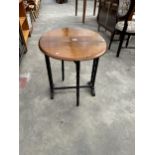 AN OVAL MAHOGANY SUTHERLAND TABLE, 26" X 21" OPENED ON TURNED EBONISED LEGS AND STRETCHERS