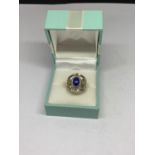 A BOXED SILVER PURPLE STONE RING