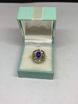 A BOXED SILVER PURPLE STONE RING