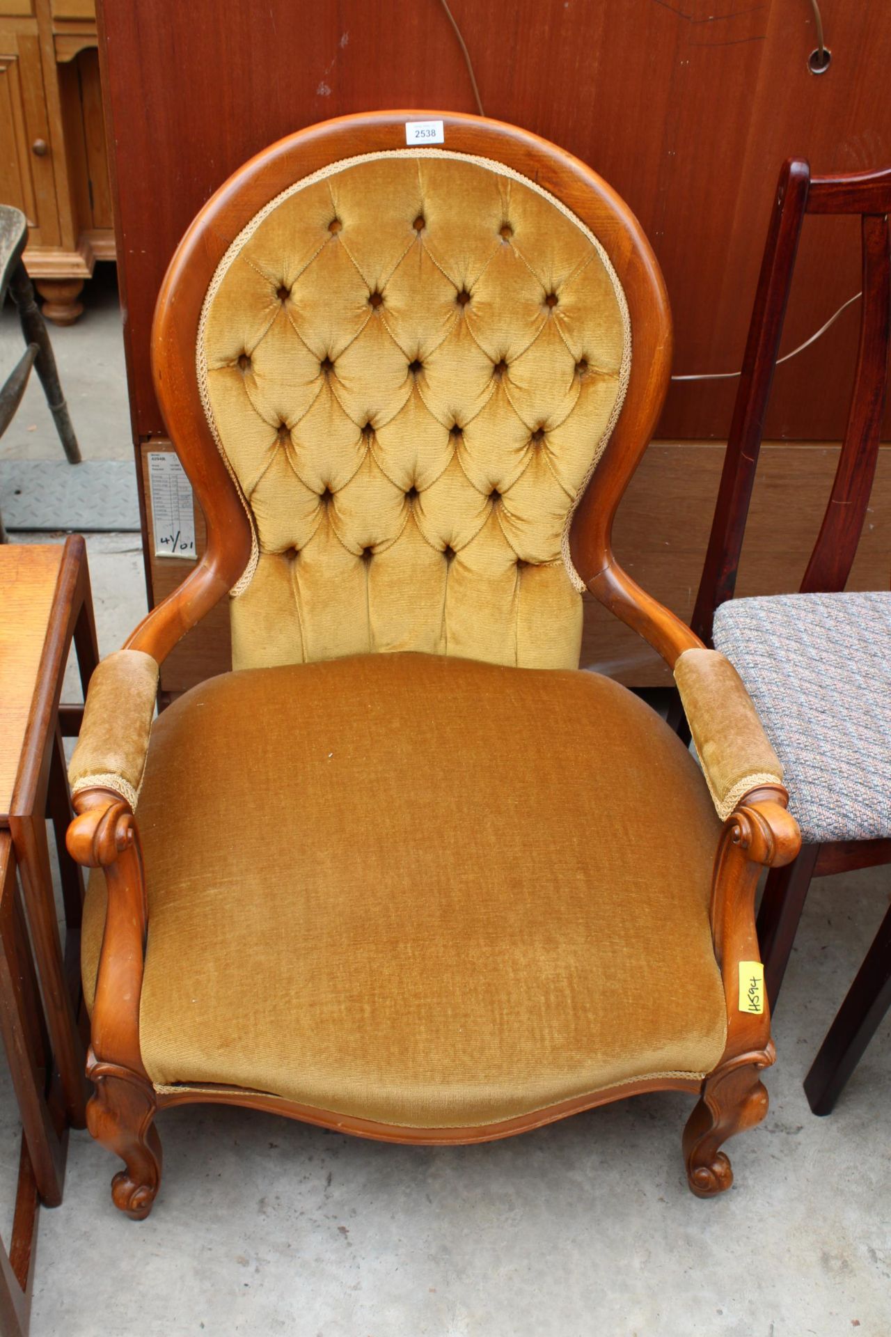 A VICTORIAN STYLE BUTTON SPOON BACK LOUNGE CHAIR WITH SWEPT OPEN ARMS