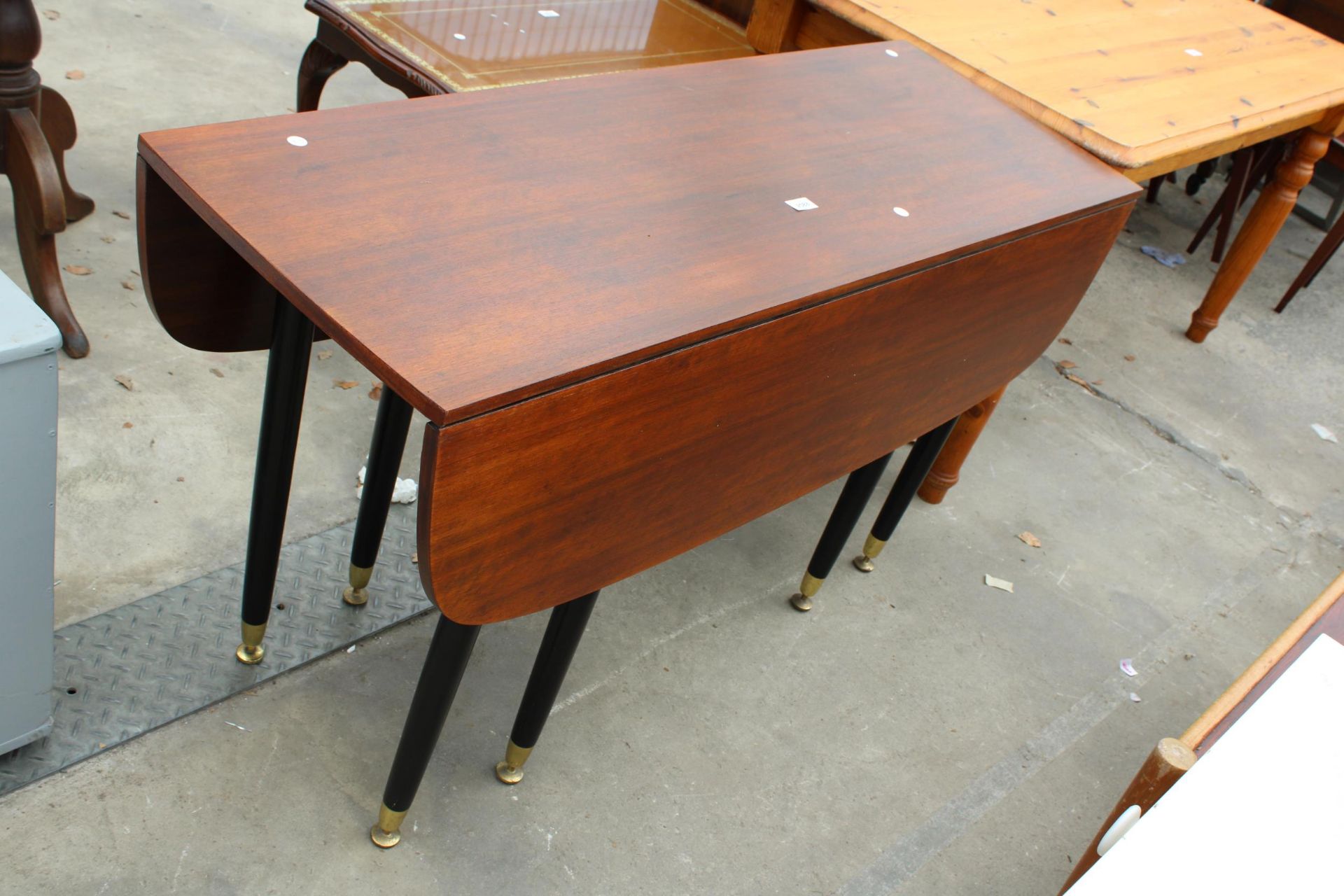 A RETRO TOLA WOOD POSSIBLY G PLAN E GOMME LIBRENZA (NO LABEL) DROP LEAF DINING TABLE ON BLACK