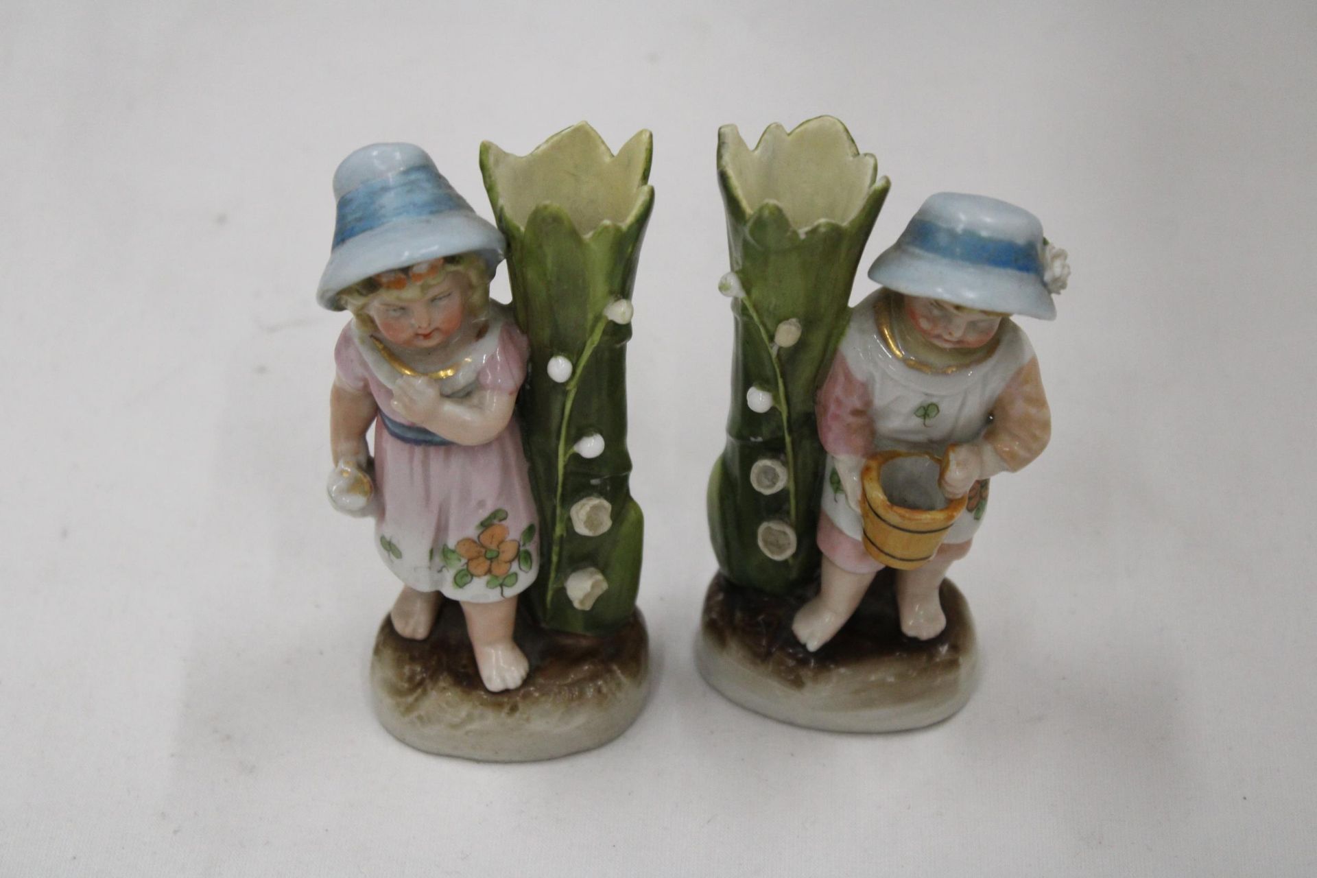 TWO VINTAGE GERMAN CONTA AND BOHME FAIRINGS TO INCLUDE A GIRL WITH JUG VASE AND A GIRL WITH BASKET