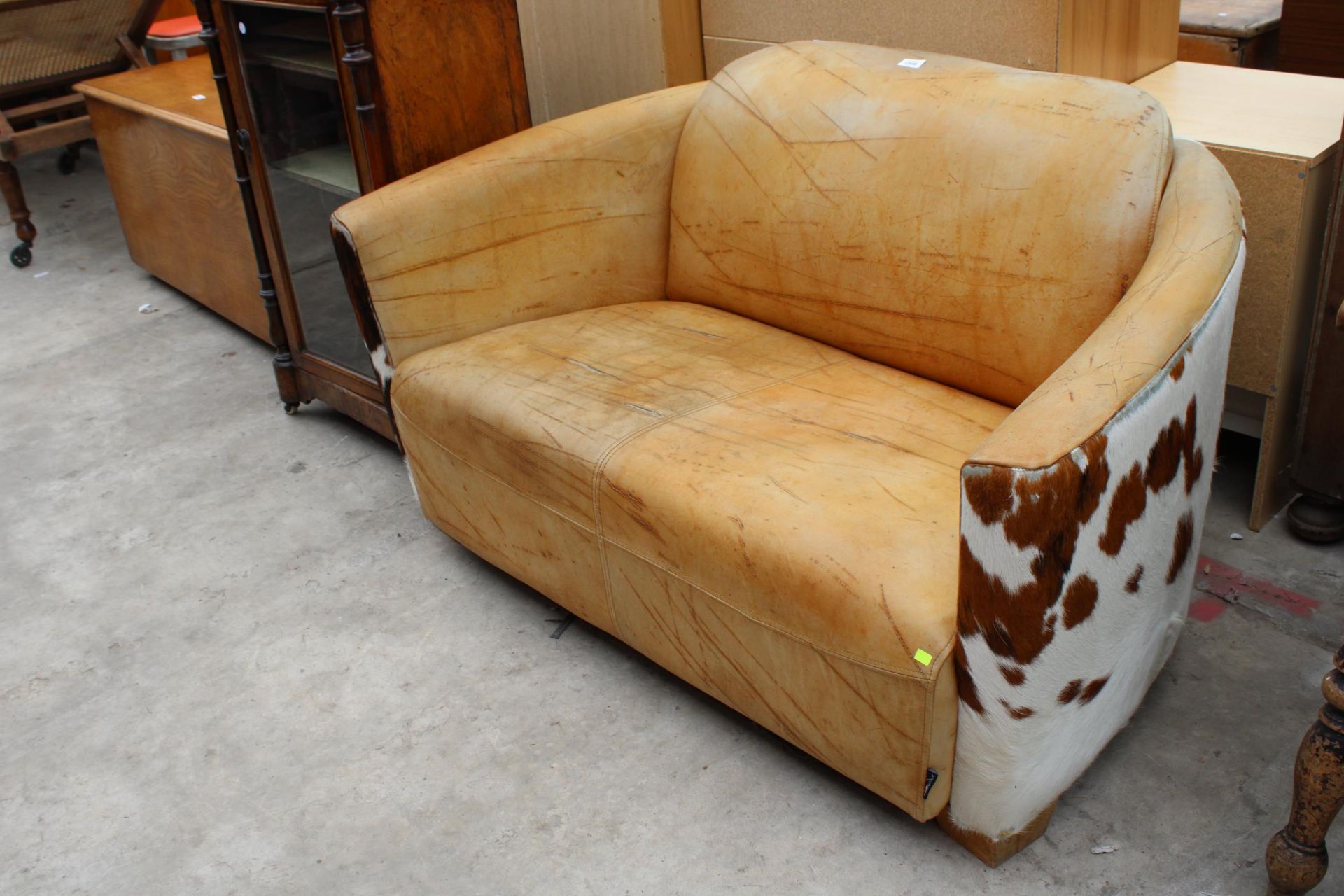 A MODERN INDIGO FURNITURE COW HIDE TWO SEATER SETTEE