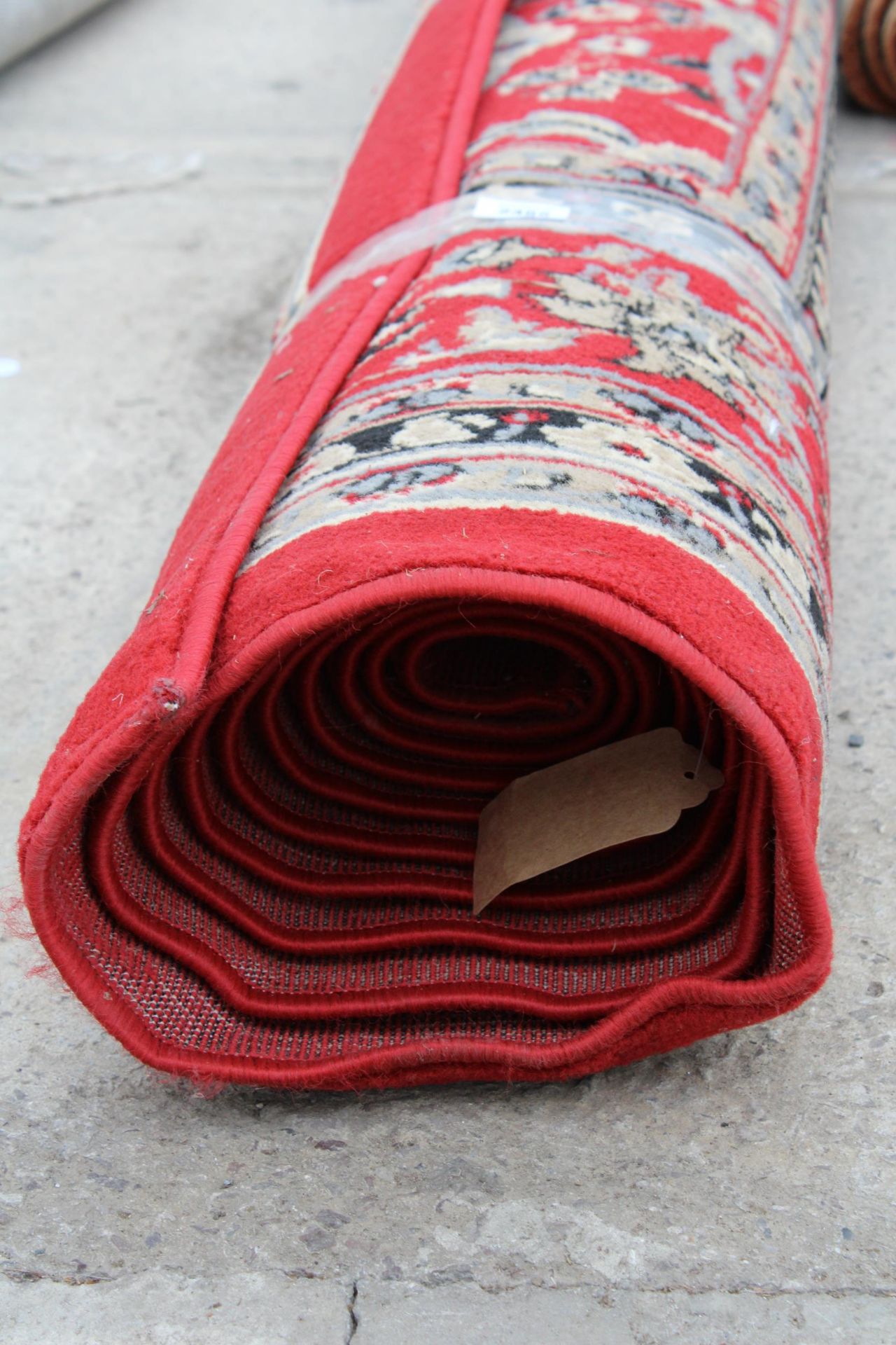 A LARGE RED PATTERNED RUG - Image 3 of 3