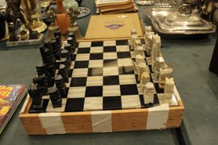 A COMPLETE MARBLE AND STONE CHESS SET WITH CARVED PIECES