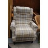 A CHECK WINGED RECLINER CHAIR