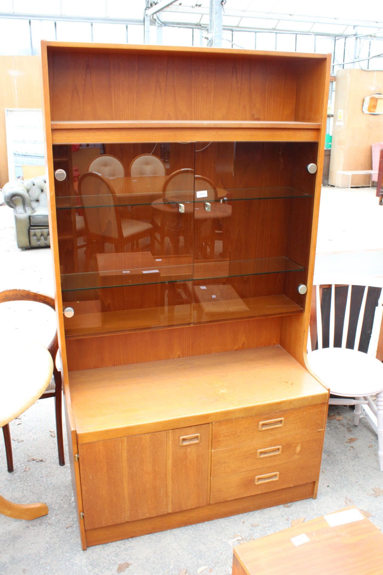 A RETRO TEAK UNIT WITH SMOKED GLASS DOORS, CUPBOARD AND DRAWERS TO BASE. 39.5" WIDE