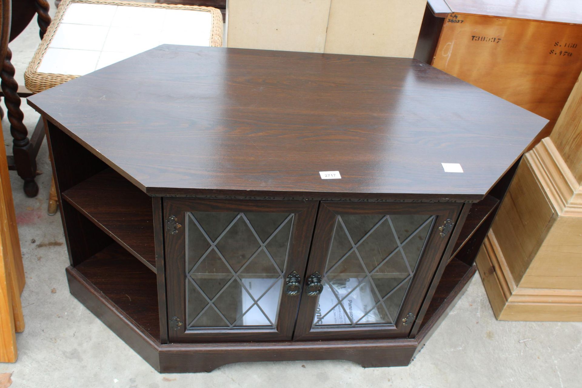 A LOW CORNER CABINET WITH GLAZED AND LEADED DOORS