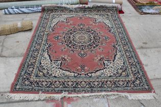 A PINK PATTERNED FRINGED RUG