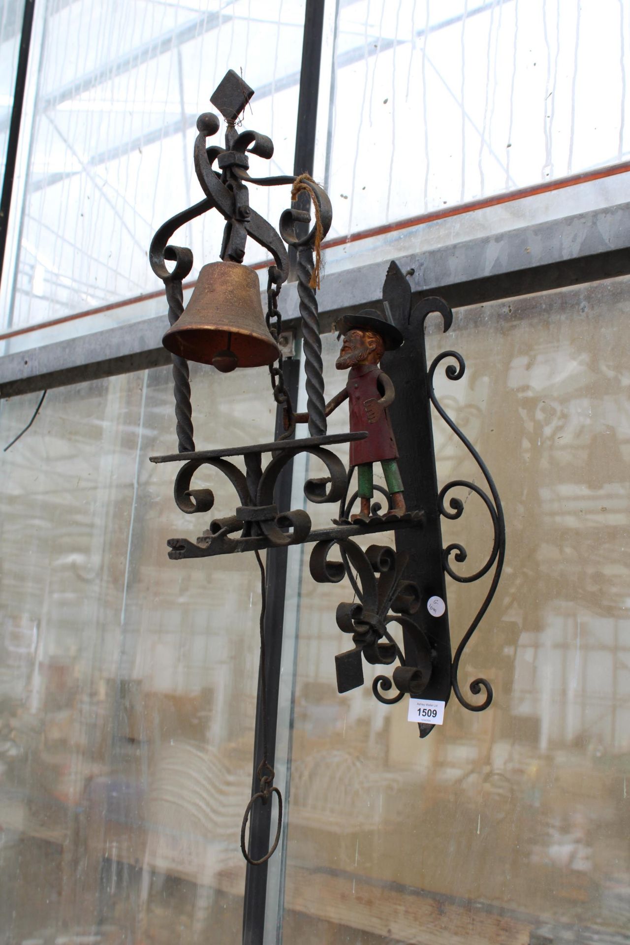 A DECORATIVE WROUGHT IRON ARTICULATING DOOR BELL