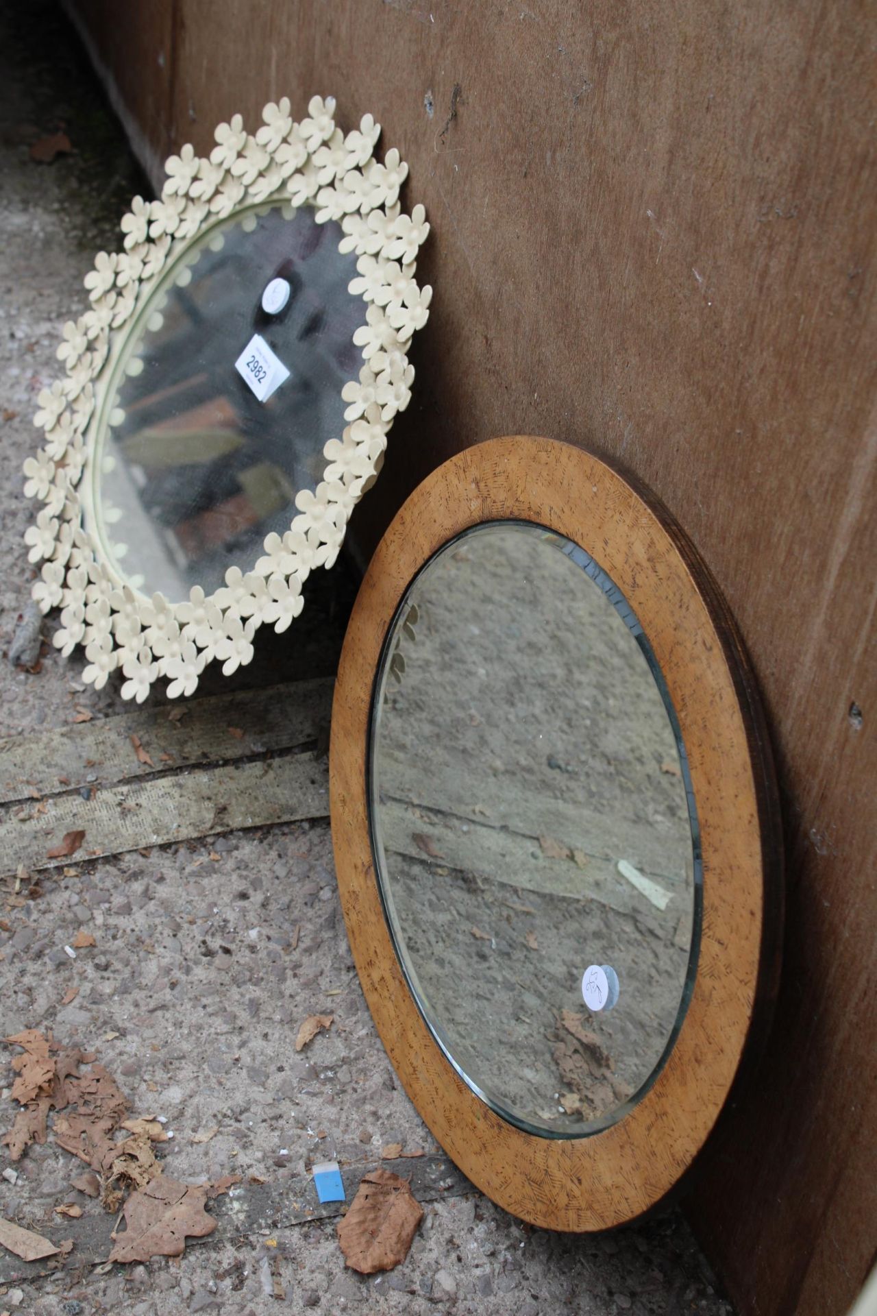 A MODERN METAL FRAMED WALL MIRROR 13" DIAMETER WITH PETAL DECORATION AND AN OVAL POKER WORK STYLE - Image 2 of 2
