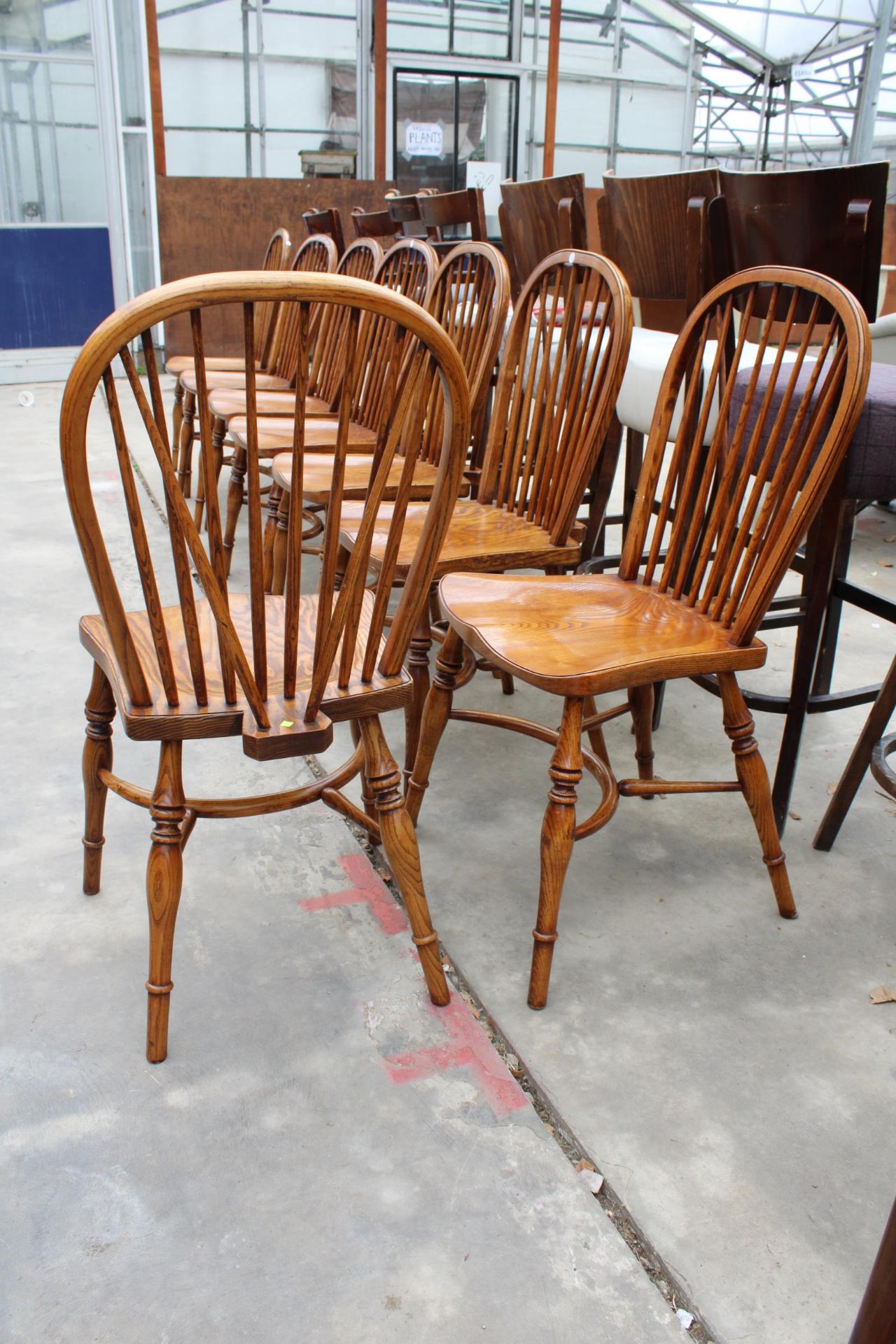 A SET OF EIGHT ELM R.W.F.CO WINDSOR STYLE DINING CHAIRS WITH STICK BACKS AND CRINOLINE BOWS - Image 9 of 9