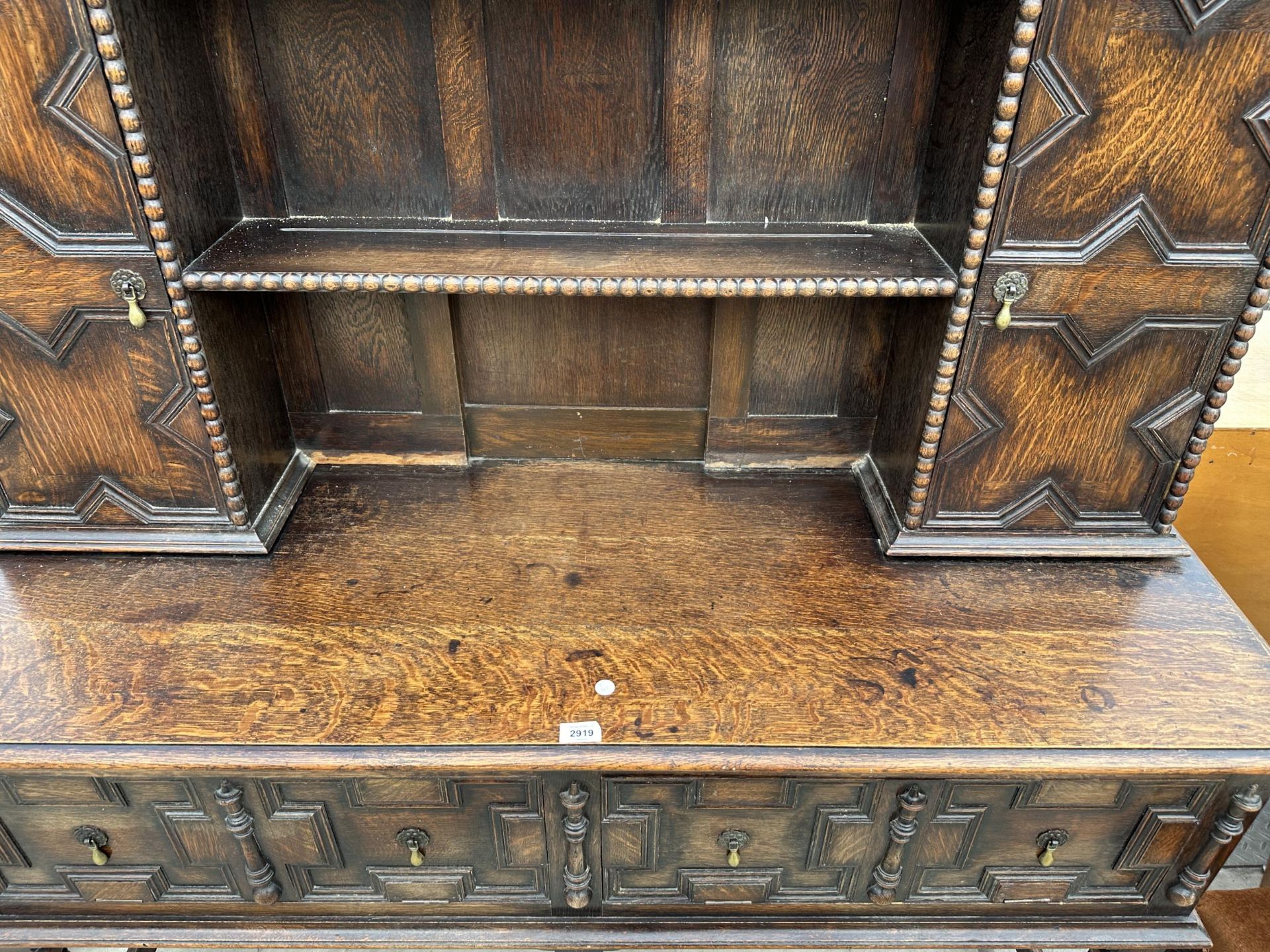 AN OAK JACOBEAN STYLE DRESSER WITH TWO FOLD-D0WN COMPARTMENTS AND A PLATE RACK ENCLOSING CUPBOARD - Image 3 of 7