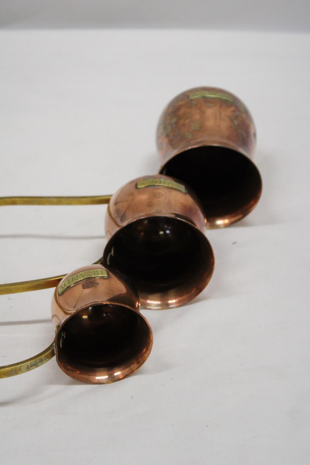 THREE VINTAGE COPPER AND BRASS MEASURING LADELS, RUM, WHISKY AND BRANDY - Image 3 of 5