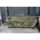 A CONCRETE GARDEN TROUGH PLANTER WITH METAL FEET (L:75CM)