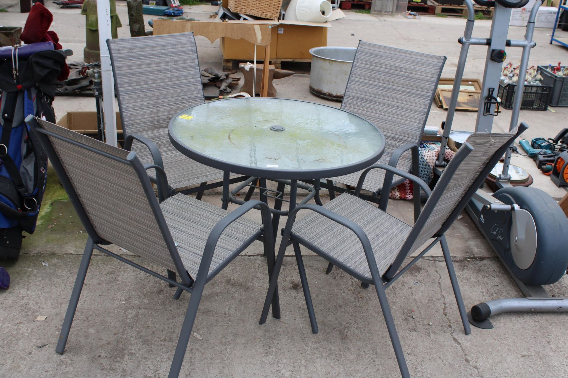 A GLASS TOPPED GARDEN TABLE AND FOUR CHAIRS