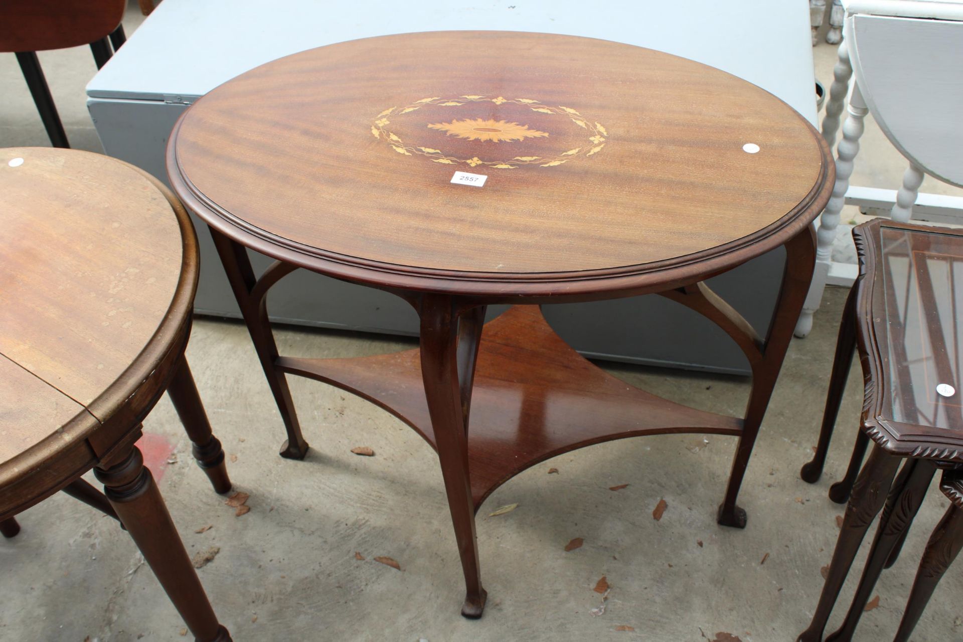 AN OVAL EDWARDIAN MAHOGANY AND INLAID TWO TIER CENTRE TABLE 33" X 22"