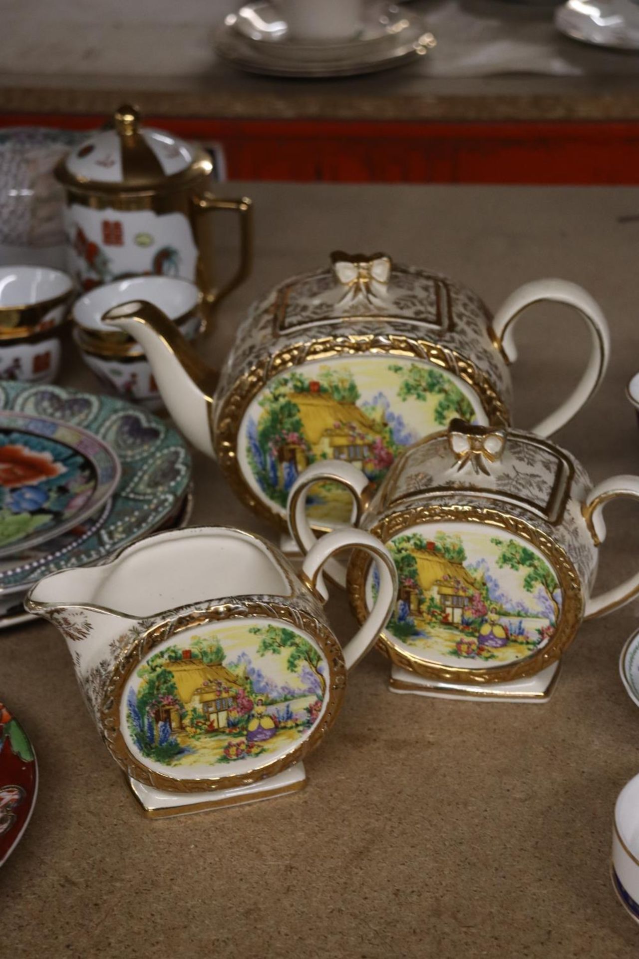 A VINTAGE SADLER TEAPOT, SUGAR BOWL AND CREAM JUG