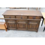 A REPRODUCTION OAK DRESSER WITH THREE LINENFOLD DOORS AND THREE DRAWERS, 54" WIDE