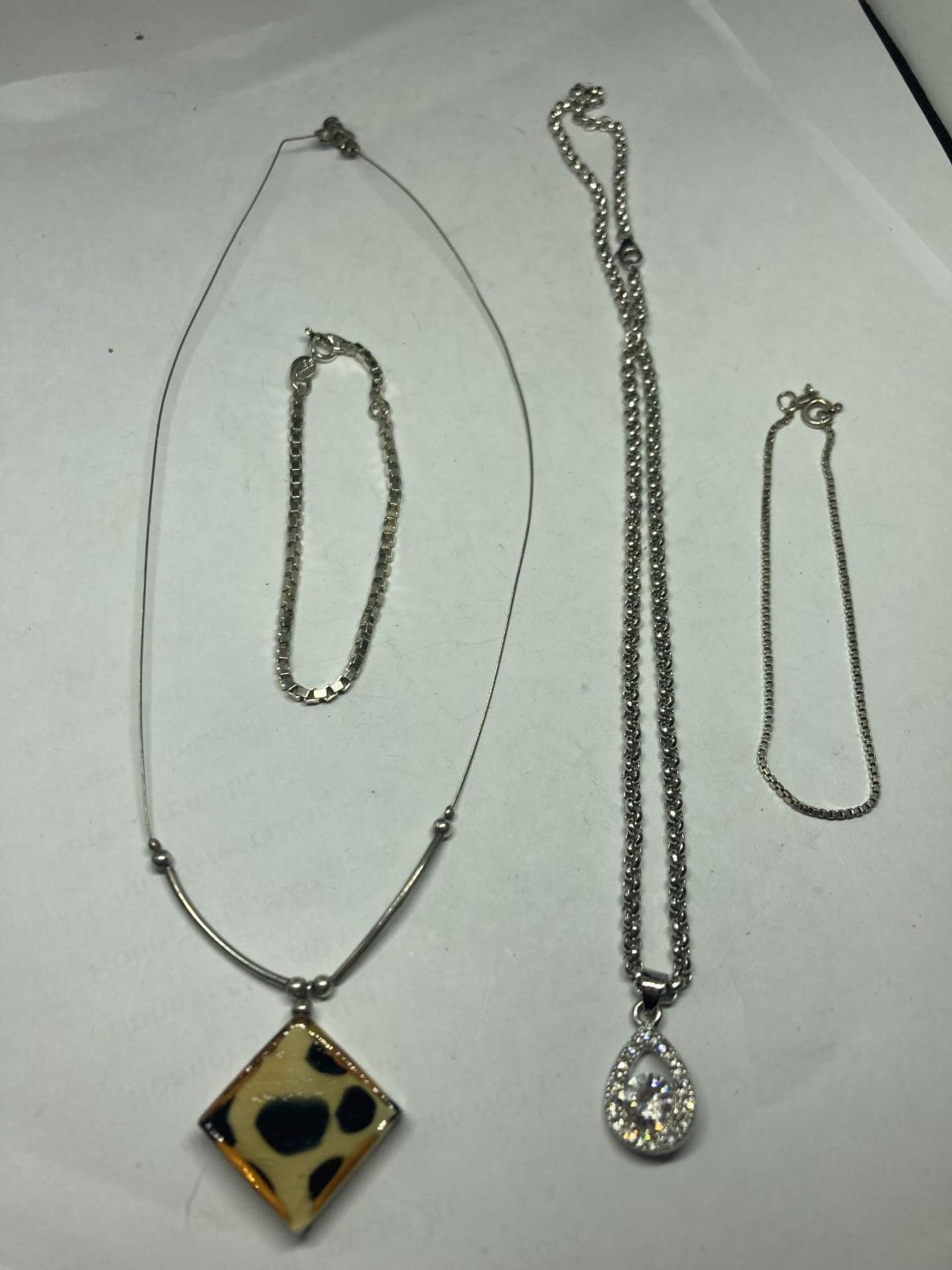 TWO SILVER NECKLACES AND BRACELETS
