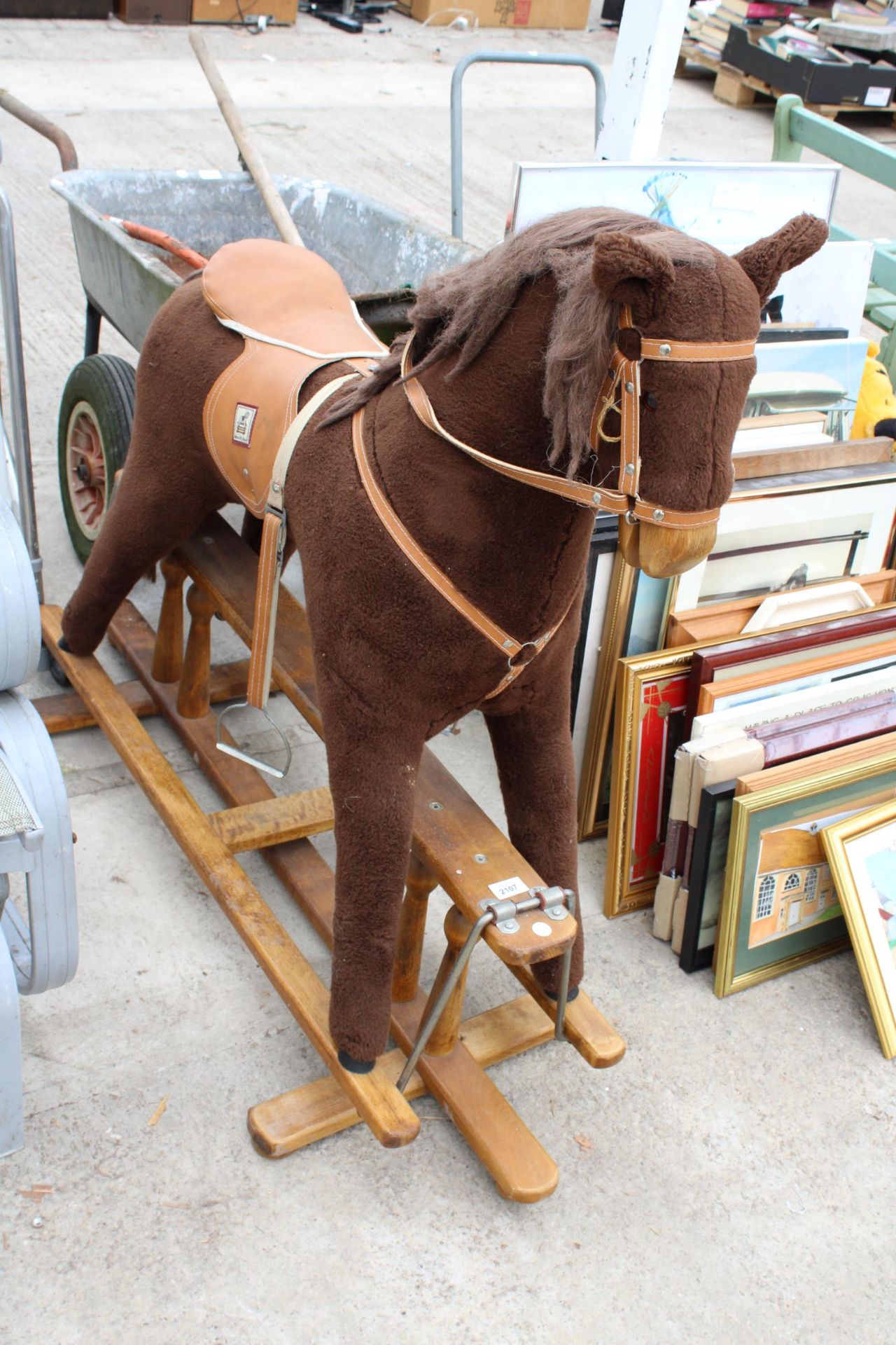 A CHILDS PLUSH AND WOODEN ROCKING HORSE