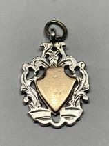 A SILVER AND GOLD WATCH FOB