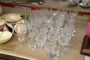 A QUANTITY OF CUT GLASS, GLASSES TO INCLUDE CHAMPAGNE FLUTES, WINE, BRANDY, SHERRY, ETC