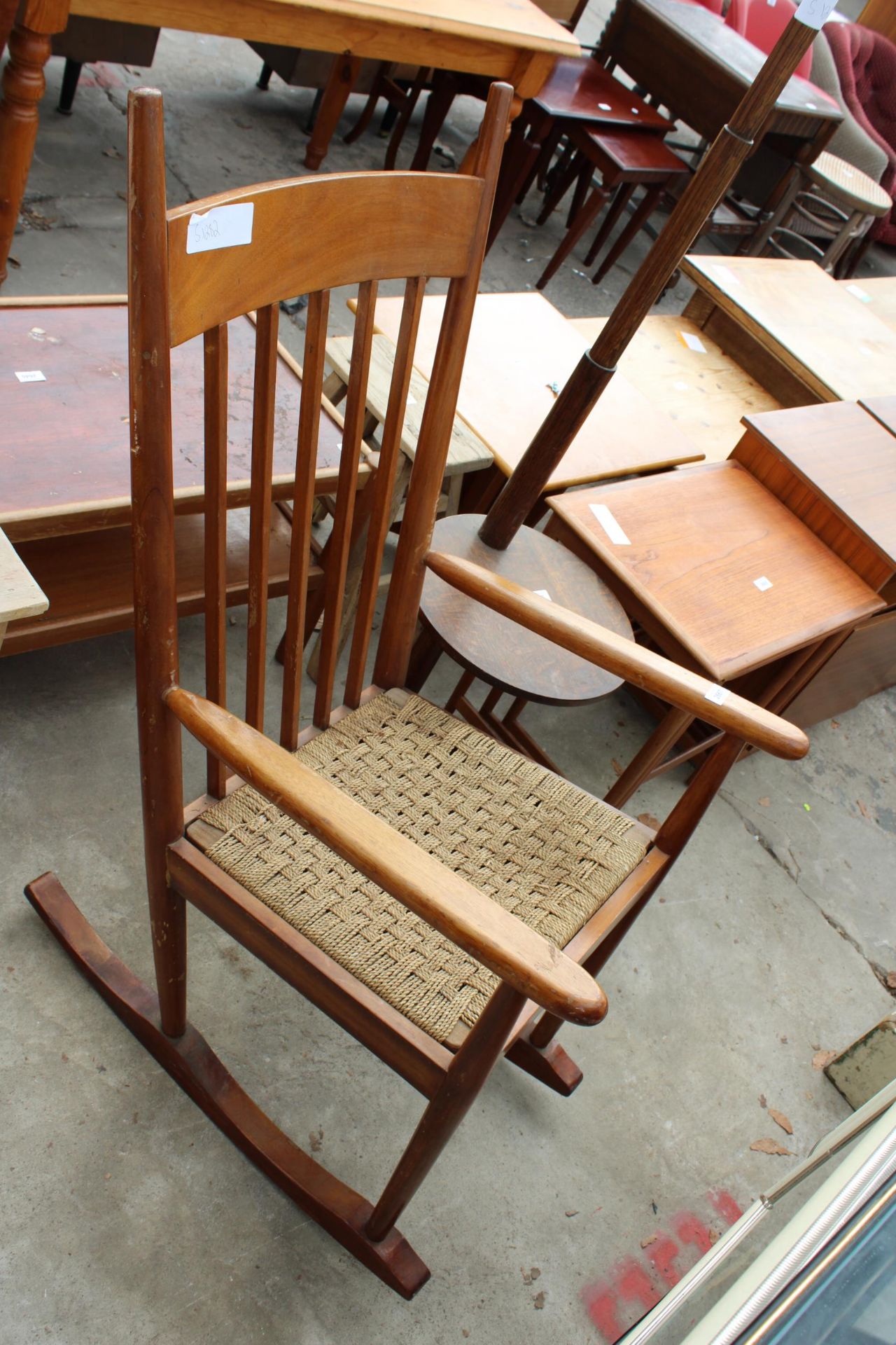 A MID 20TH CENTURY HARDWOOD ROCKING CHAIR WITH DROP-IN WOVEN SEAT