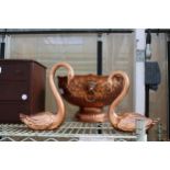 A VINTAGE COPPER PUNCH BOWL WITH LION HEAD HANDLES AND TWO COPPER COLOURED SWAN FIGURES