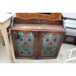 A MID 20TH CENTURY OAK CABINET WITH GALLERY TOP AND TWO GLAZED AND LEADED DOORS, 30" WIDE